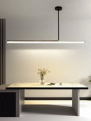 Retro 70s Neon Kitchen Island Pendant in Black or White illuminating a modern kitchen table with floral decor.