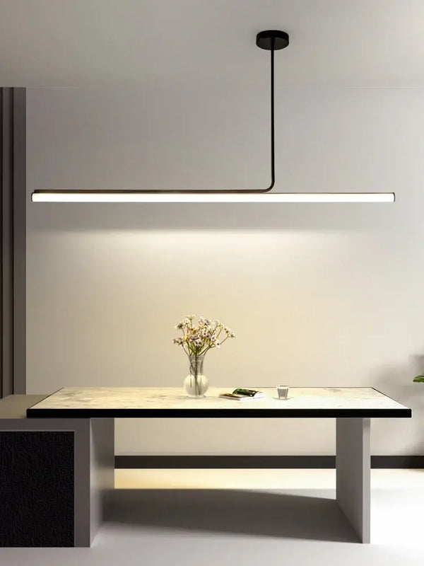 Retro 70s Neon Kitchen Island Pendant in Black or White illuminating a modern kitchen table with floral decor.