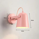 Nordic Bell Bedside Wall Lamp in pink with adjustable shade and sturdy metal construction.
