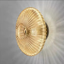Radiant Modern Glass Wall Lamp with elegant ribbed glass design in amber color, showcasing a warm light effect.