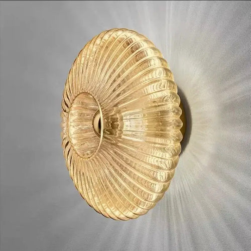Radiant Modern Glass Wall Lamp with elegant ribbed glass design in amber color, showcasing a warm light effect.