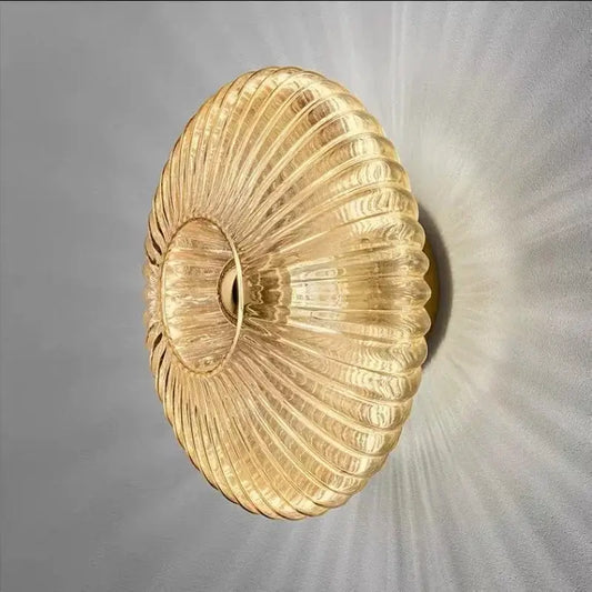 Radiant Modern Glass Wall Lamp with elegant ribbed glass design in amber color, showcasing a warm light effect.