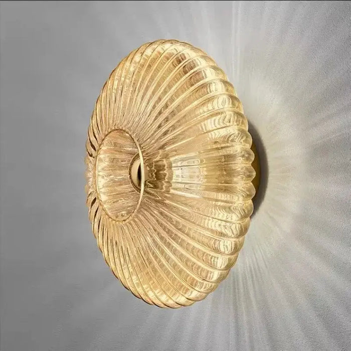 Radiant Modern Glass Wall Lamp with elegant ribbed glass design in amber color, showcasing a warm light effect.