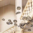 Nordic Cloud Glass Pendant Light – Smoky Grey Designer LED Chandelier hanging decoratively over a staircase.
