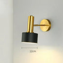 Gold Wall Mounted Spot in Brass and Black Colours featuring a sleek design on a wall.