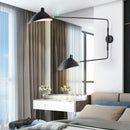 Swing Arm Nordic Loft Wall Lamp elegantly displayed in a stylish bedroom with modern decor.