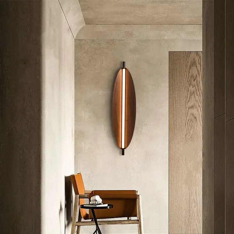 Modern Brown Leaf Wall Light – Sculptural LED Wall Sconce in Metal illuminating a contemporary hallway.