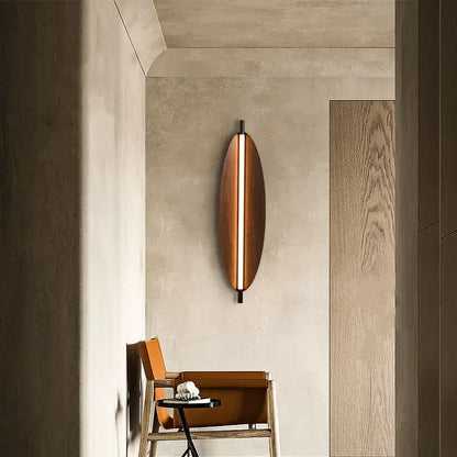 Modern Brown Leaf Wall Light – Sculptural LED Wall Sconce in Metal illuminating a contemporary hallway.