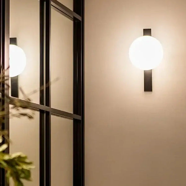 Minimalist Nordic Wall Lamp with Frosted White Ball illuminating a stylish interior.