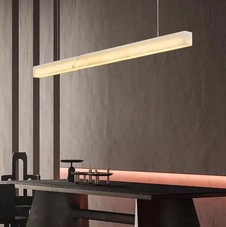 Natural Marble Linear Pendant Light 80–120cm hanging above a modern dining table, enhancing contemporary decor.