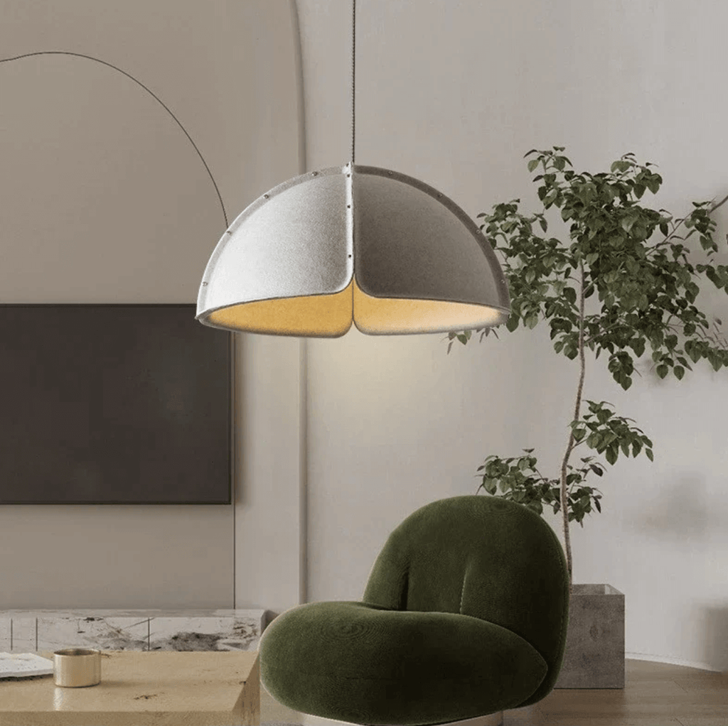 Italian Designer Felt Pendant Light – Sculptural Dome for Dining Rooms and Kitchens in a modern living space with green chair.