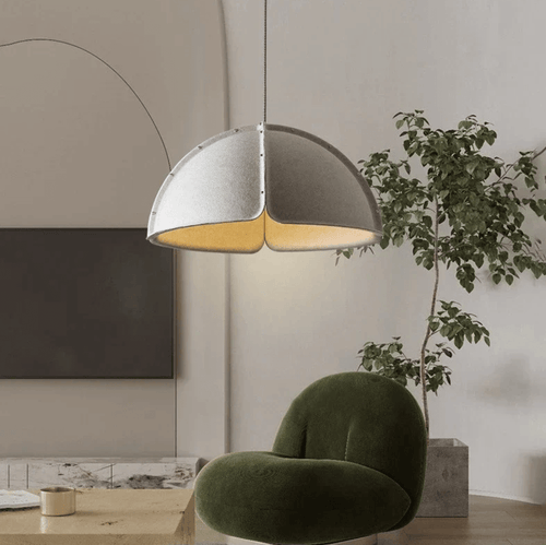 Italian Designer Felt Pendant Light – Sculptural Dome for Dining Rooms and Kitchens in a modern living space with green chair.