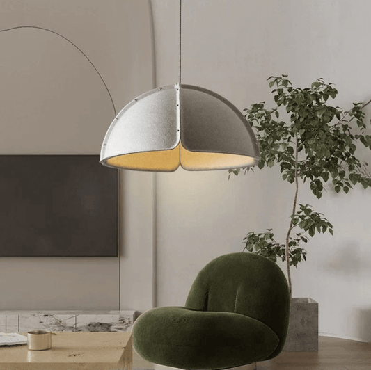 Italian Designer Felt Pendant Light – Sculptural Dome for Dining Rooms and Kitchens in a modern living space with green chair.