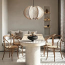 Nordic Spider Web Pendant Light inspired by the 70s! illuminating a modern dining space with rustic decor.