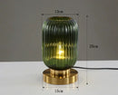 Modern Nordic Glass Table Lighting Fixtures in green with gold base, 25cm tall, enhancing your decor.
