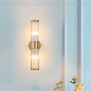 Bathroom Art Deco Brass and Crystal Sconces illuminating a stylish bathroom wall, featuring sleek design and elegant lighting.