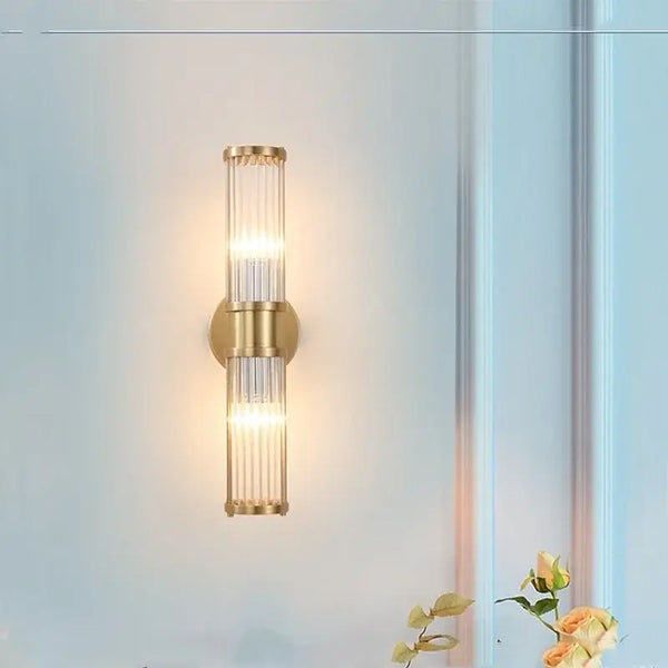 Bathroom Art Deco Brass and Crystal Sconces illuminating a stylish bathroom wall, featuring sleek design and elegant lighting.