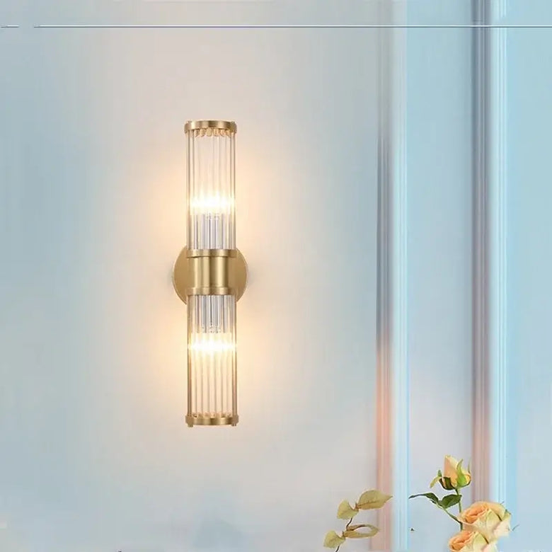 Bathroom Art Deco Brass and Crystal Sconces illuminating a stylish bathroom wall, featuring sleek design and elegant lighting.