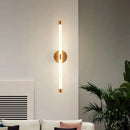 Postmodern Tube Pipe  Wall Light in gold illuminating a stylish living room with modern decor.