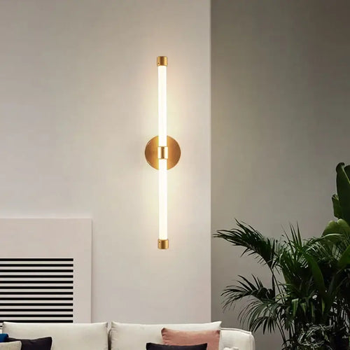 Postmodern Tube Pipe  Wall Light in gold illuminating a stylish living room with modern decor.