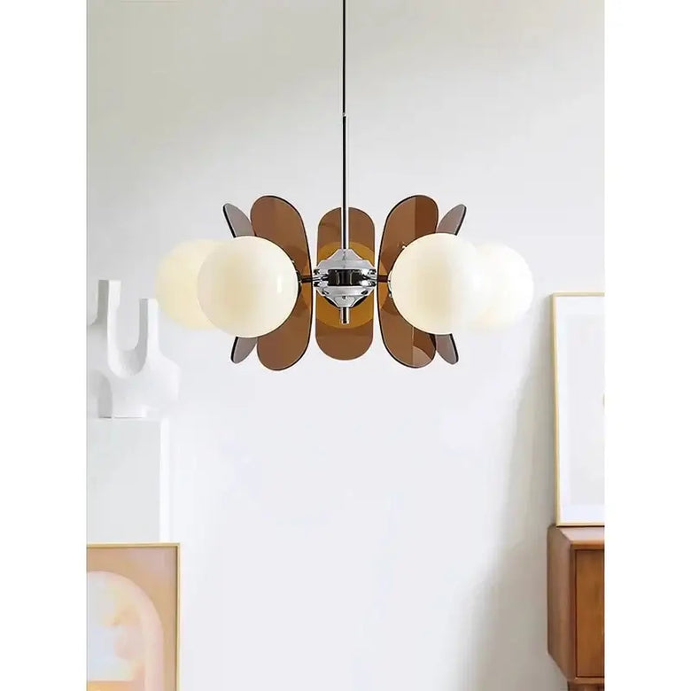Rare Mid-Century Orange Plexiglass Chandelier: A Unique Vintage Gem showcasing oval orange reflectors and white frosted glass balls.