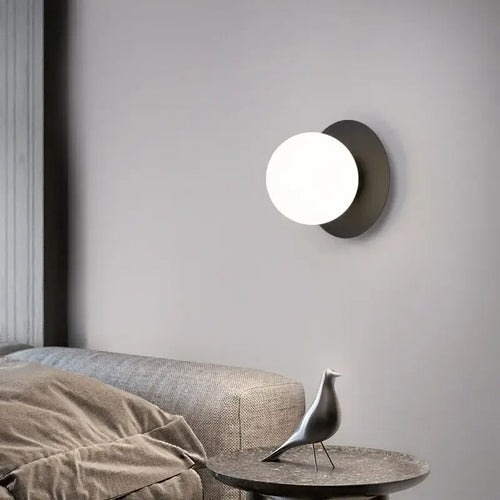 Simple Round Wall Lamp illuminating a stylish living room with modern decor and furniture.