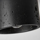 Close-up of the Black Travertine Ceiling Lamp showcasing its textured surface and modern design.