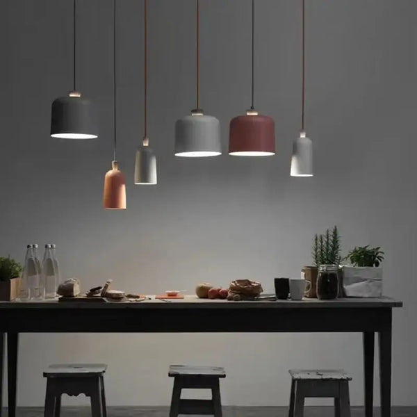 Colourful, modern, metal Danish Light Pendant illuminating a dining table with minimalist decor.