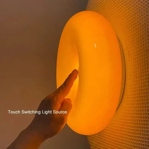 Glass Donut Wall Lamp with touch switching feature and warm lighting experience.