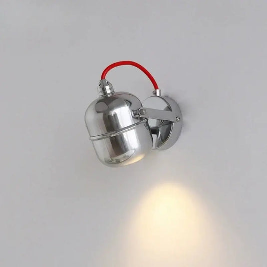 hero Metallic wall light fixture on a plain background