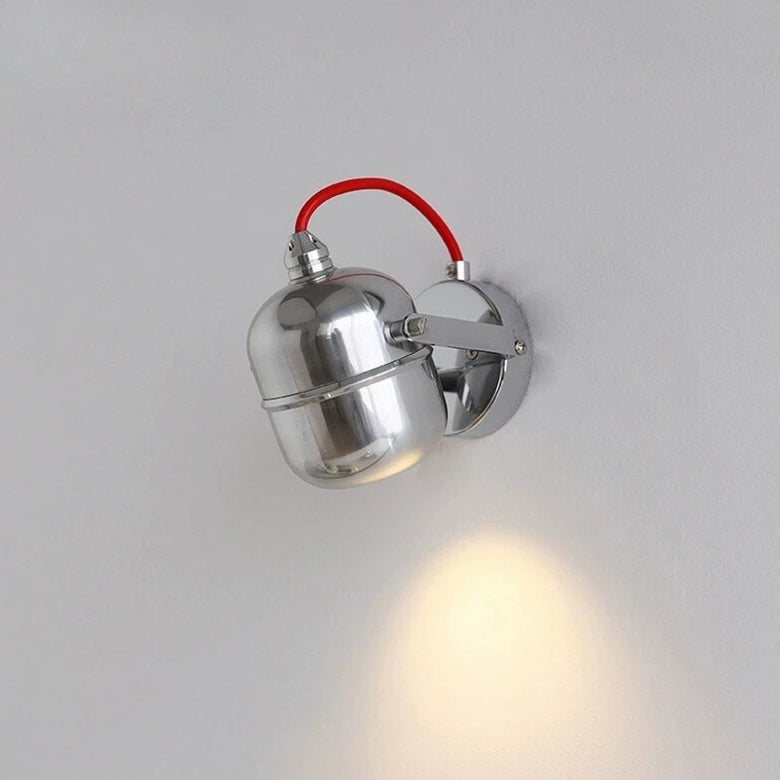 hero Metallic wall light fixture on a plain background