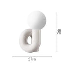 Sculptural Resin Table Lamp – Italian-Inspired Modern Lighting featuring a frosted glass globe.