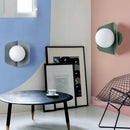 Chic Modern Sconce Collection – Illuminate with Style showcased in a stylish room with blue and pink walls.