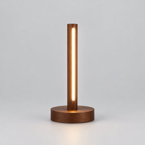 A modern cylindrical LED desk lamp with a warm glowing vertical light bar and a round wooden base,