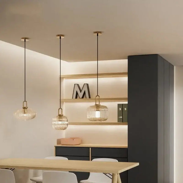 Pendant Light: Modern Nordic Glass Hanging Lighting Fixtures in a stylish dining area with elegant shelving.