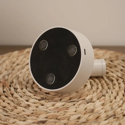 USB Recharge Wall Mounted Spotlight on a woven surface showcasing its sleek, modern design.