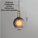 Grey Frosted Sphere Glass Hanging Lamp featuring a small size, frosted grey shade, and gold accent, ideal for versatile decor.