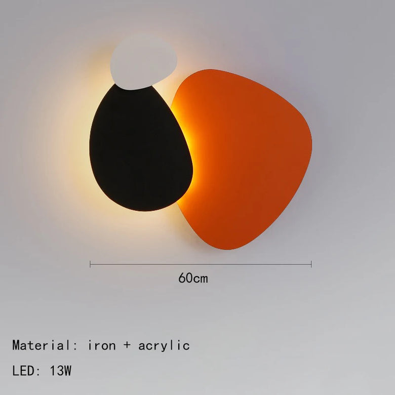 Modern wall lamp with black and orange design on a gray background