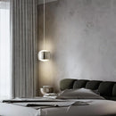 French Nouvelle Vague Pendant Light illuminating a modern bedroom with minimalist decor and soft textures.