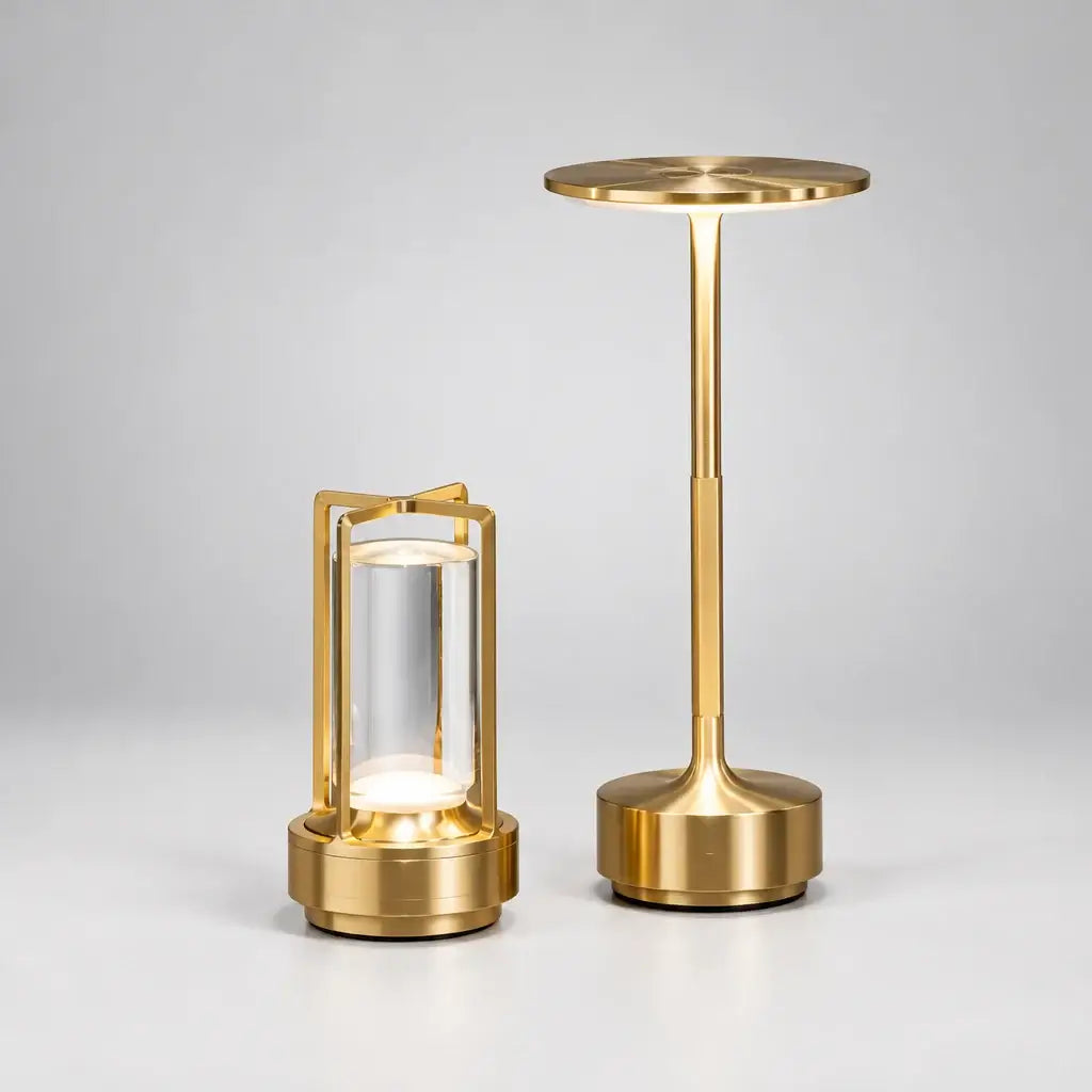 Gold cordless table lamps, a disc lamp and a lantern lamp, on a Grey table and background