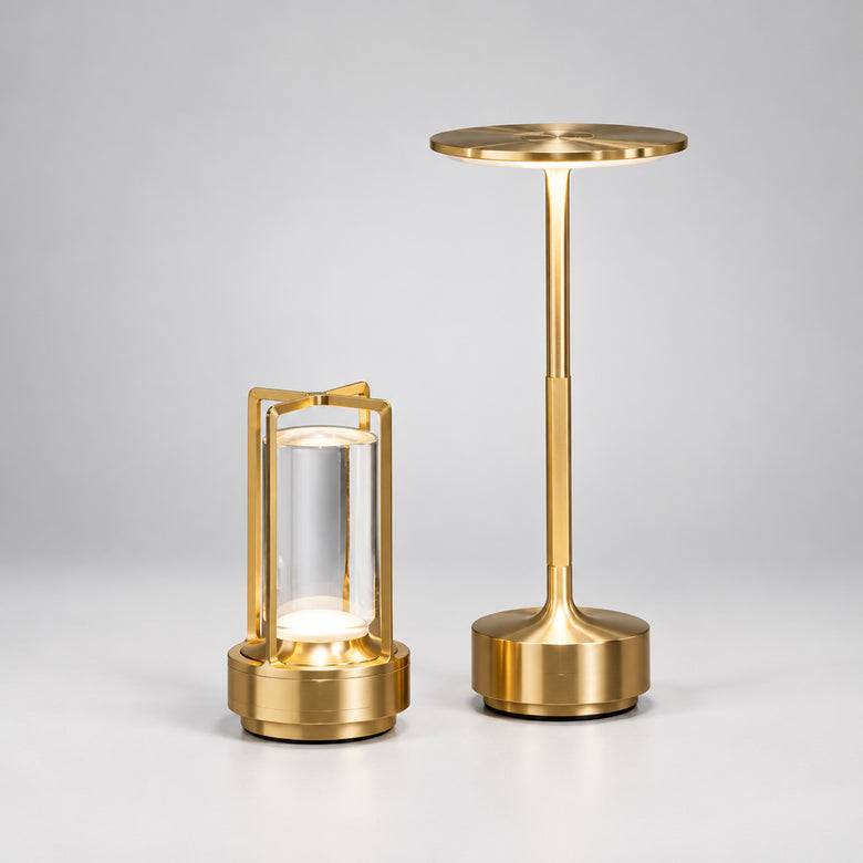 Two gold table lamps on a wooden surface with a blurred background