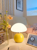 Mushroom LED USB Table Lamp in Pink – Soft Glow Bedside Lighting on a table with flowers and a tablet.