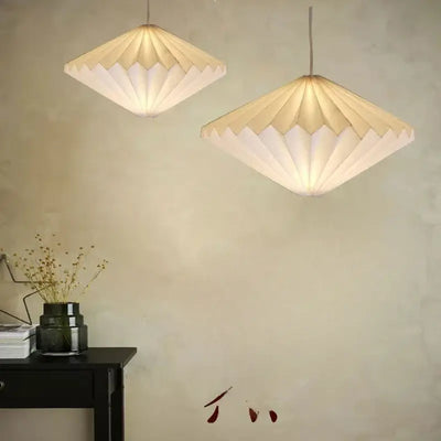 Elegant Origami-Inspired Paper Lantern illuminating a stylish living space with minimalist design.