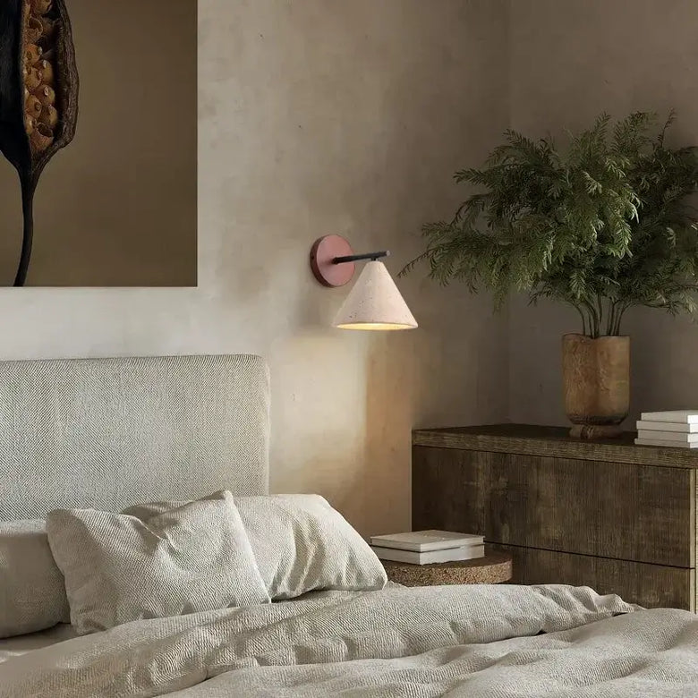 Natural Travertine Stone Wall Lamp – Modern LED Sconce for Bedrooms illuminating a cozy bedroom with modern decor.