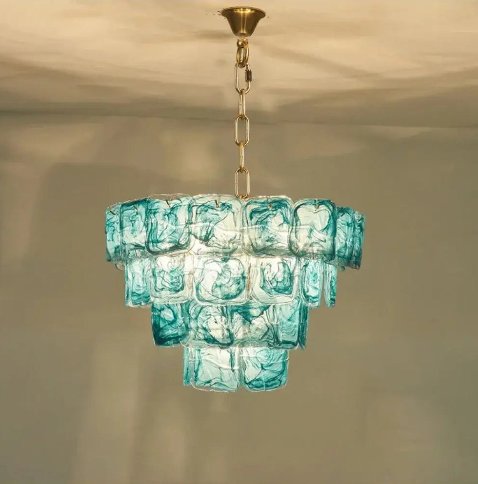 Blue Glass Chandelier with Polished Chrome Finish lighting up a room with its unique design and artisan craftsmanship.