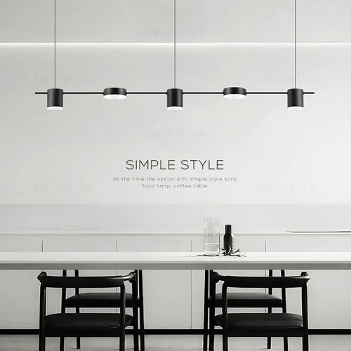 Hanging Minimalism Lights showcasing a stylish and modern design over a dining table in a contemporary setting.