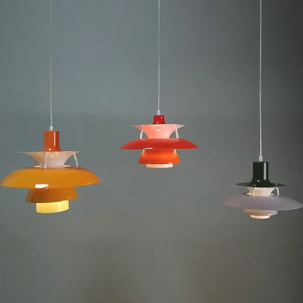 Classic Nordic Designer Pendant Lights Available in 3 different sizes in vibrant colors hanging against a grey background.