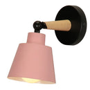 Nordic Solid Wood Bedroom Wall Lamp with pink shade and sleek iron finish, perfect for modern decor.