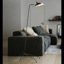 Nordic Designer Tripod Floor Lamp next to a cozy couch in a modern living room setting.