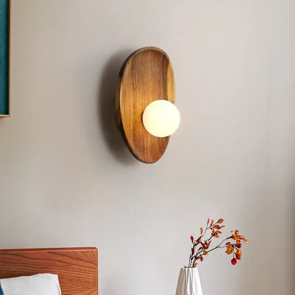 Vintage Walnut Wall Light illuminating a bedroom wall with a warm frosted glass bulb.